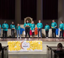 Members of the Take Back the Night planning committee on stage in matching shirts